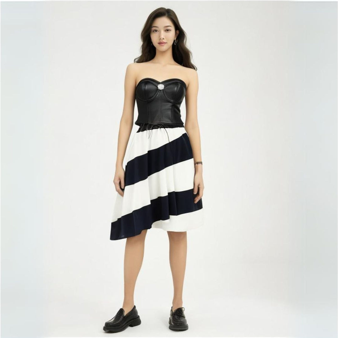 Saint Livia black leather bustier for women UK, styled full-length lifestyle shot with striped skirt