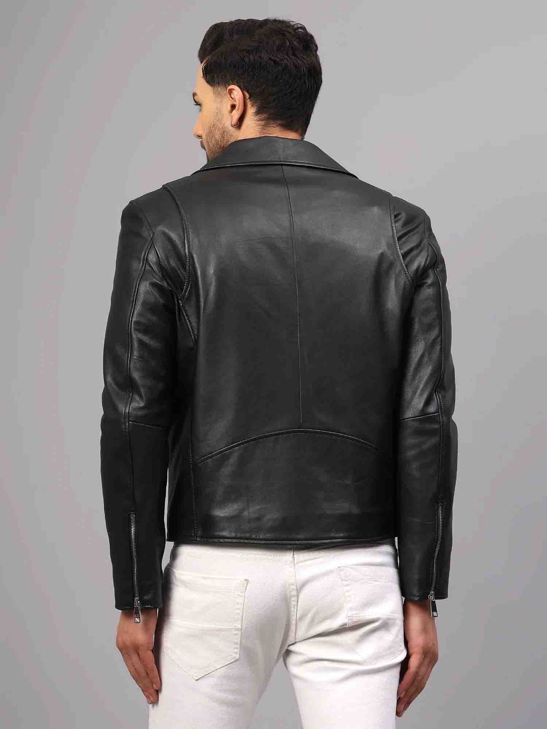 Back view of a man wearing a black leather biker-style jacket.