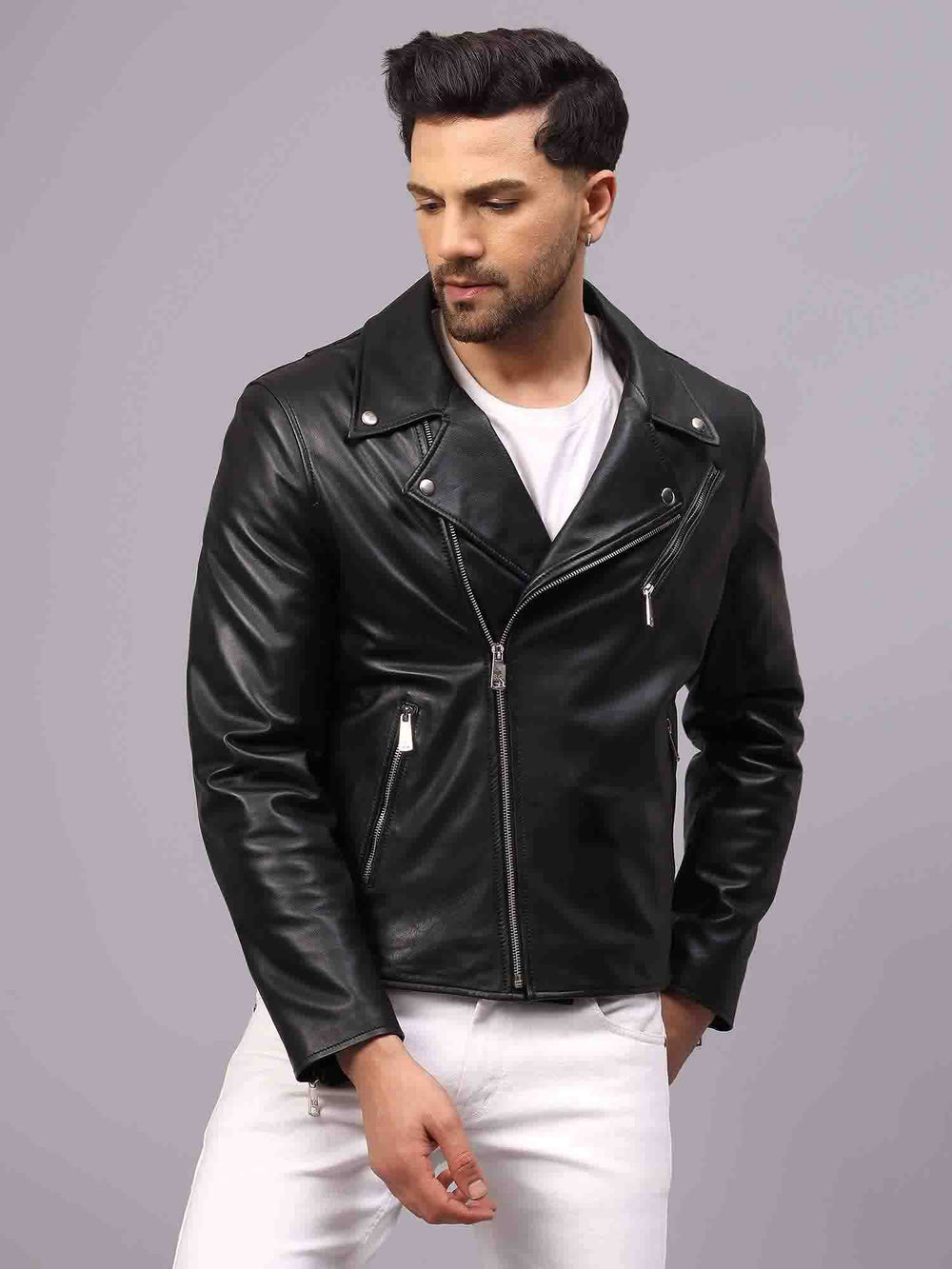 Man wearing an open black leather biker-style jacket with a notched lapel.