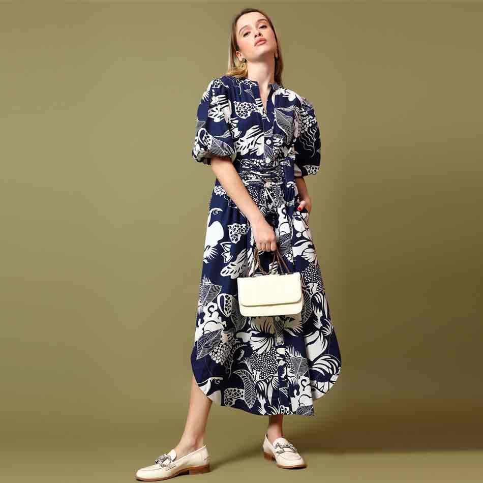 Saint Louise navy white botanical print midi dress for women UK, three-quarter front view with handbag.