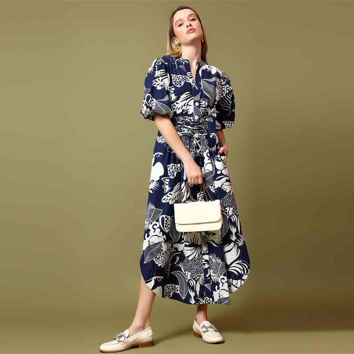 Saint Louise navy white botanical print midi dress for women UK, three-quarter front view with handbag.