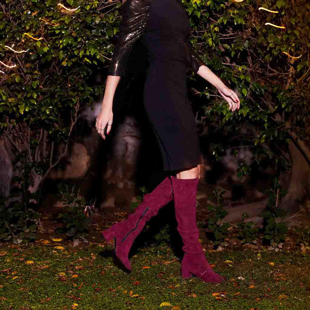Women's maroon suede thigh high boots UK by Saint Luisa, styled night-time walking lifestyle shot