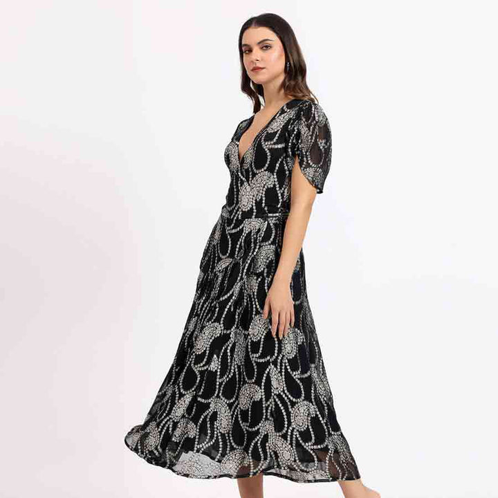 Women's black ivory paisley tea-length dress by Saint Maisie, side view showing full hem sweep.