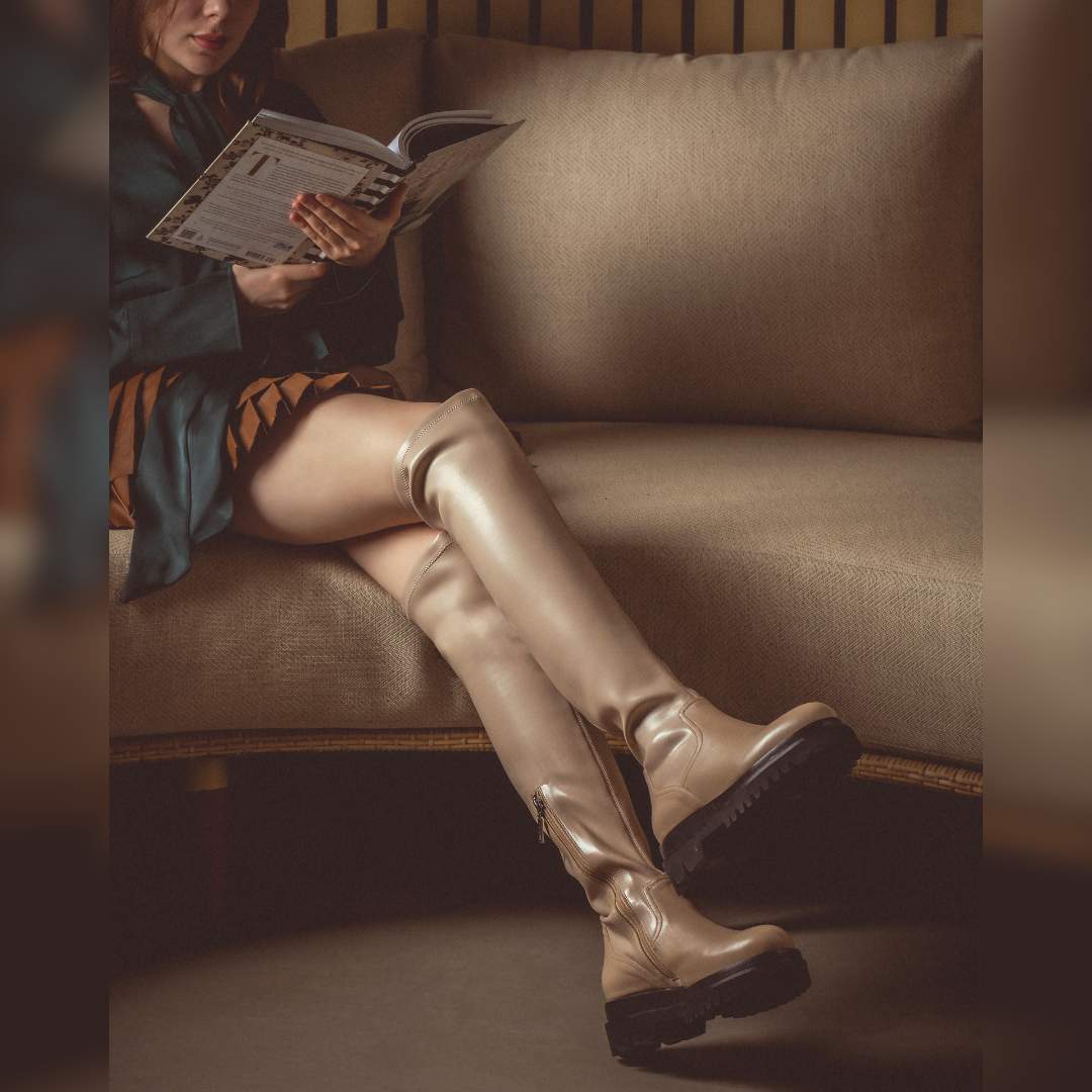 Women's taupe thigh high boots by Saint Malia, styled seated lifestyle shot