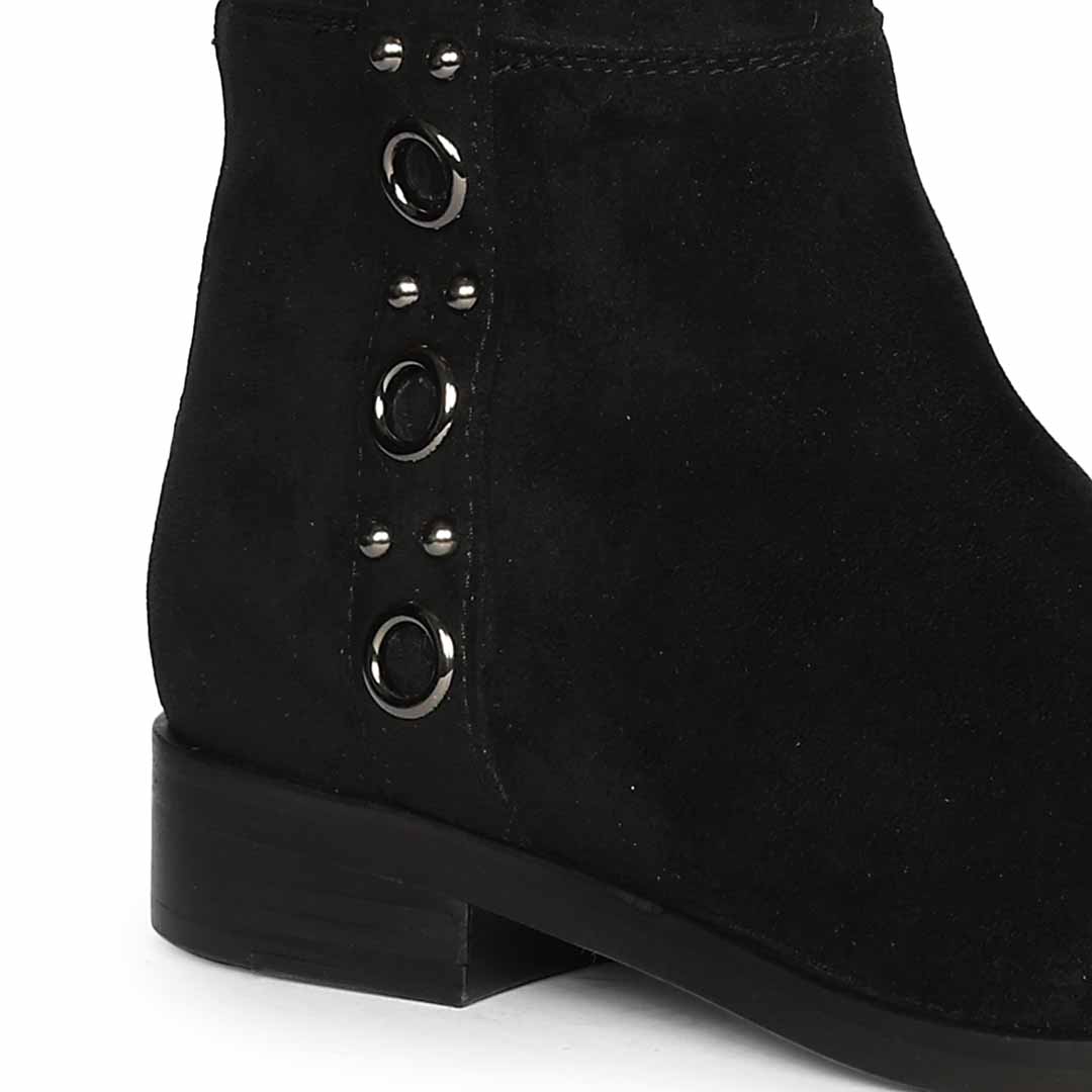 Close-up of eyelet trim on Saint Marlowe black stretch suede long boots