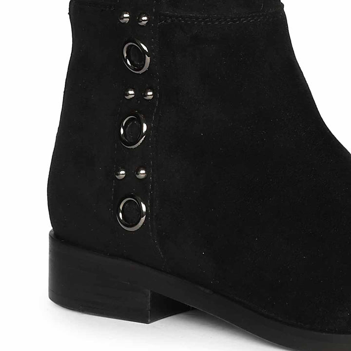 Close-up of eyelet trim on Saint Marlowe black stretch suede long boots