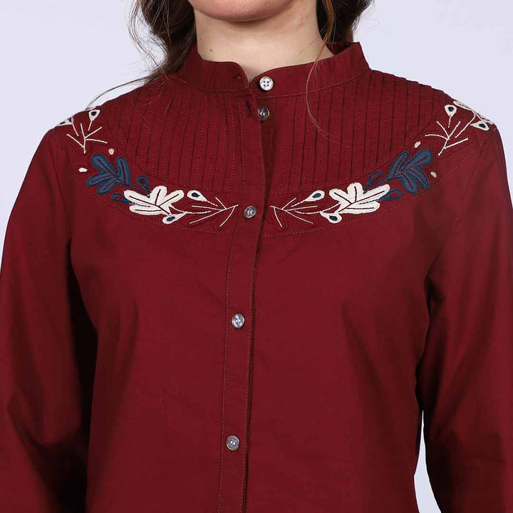 Close-up of pintuck pleating and floral embroidery on Saint maroon cotton top for women UK.
