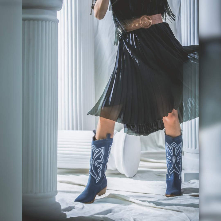 Women's denim suede cowboy boots by Saint Martina, styled editorial lifestyle shot