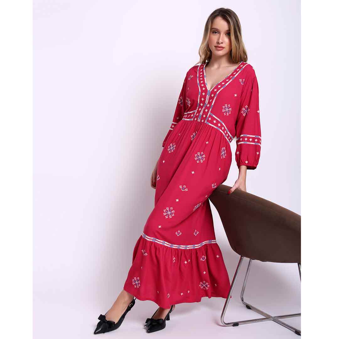 Women's red long dress by Saint Martine, side view showing floor-length hem.