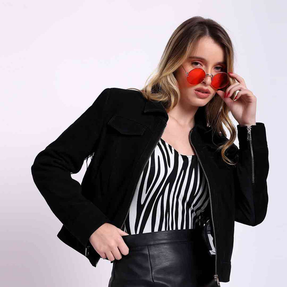 Women's black suede jacket UK by Saint Melanie, styled lifestyle shot with sunglasses