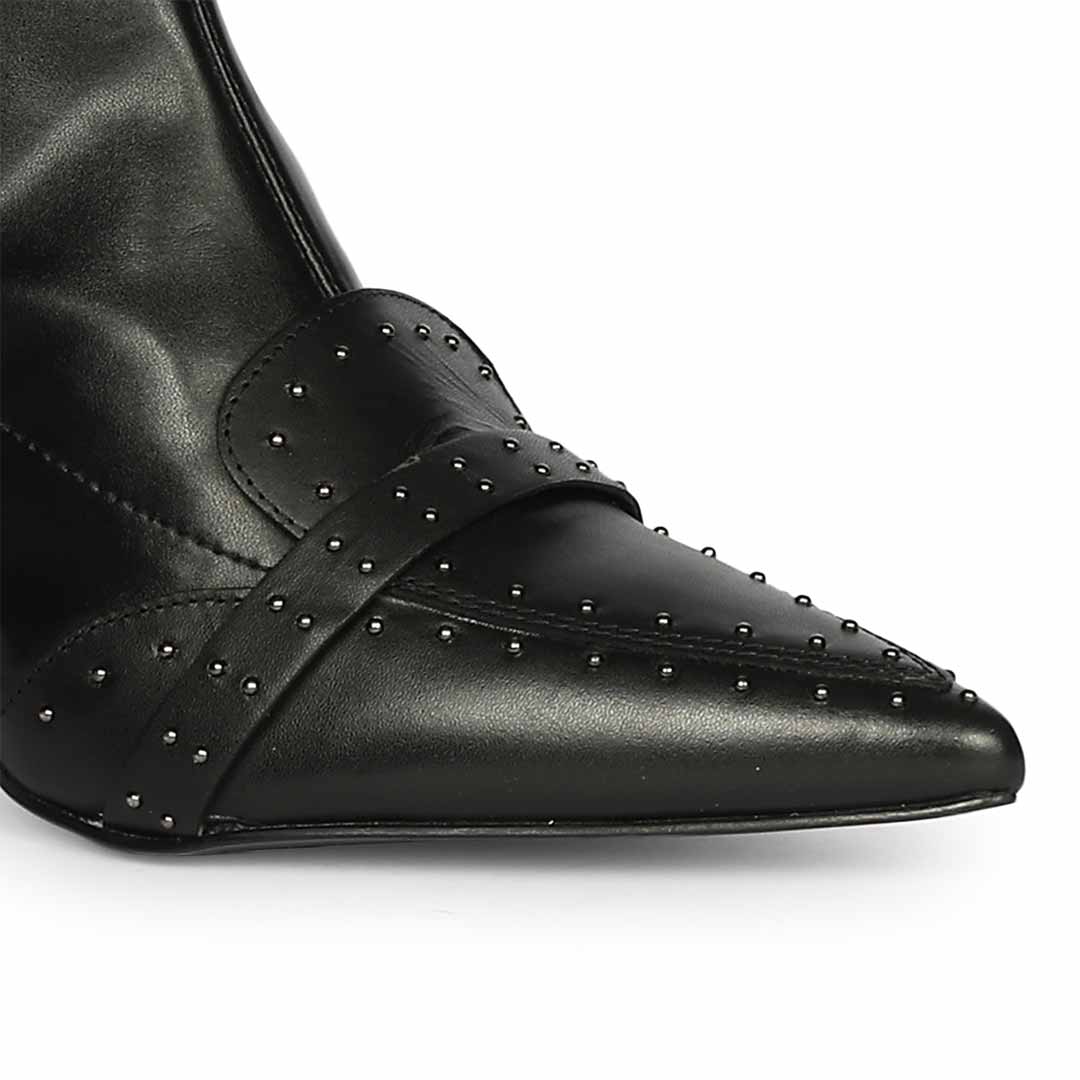 Close-up of studded toe strap detail on Saint Meribel black knee high boots
