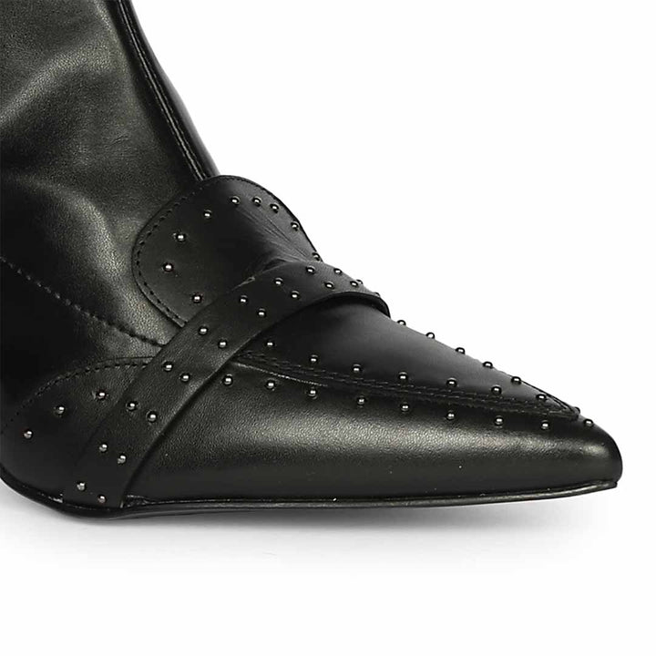 Close-up of studded toe strap detail on Saint Meribel black knee high boots