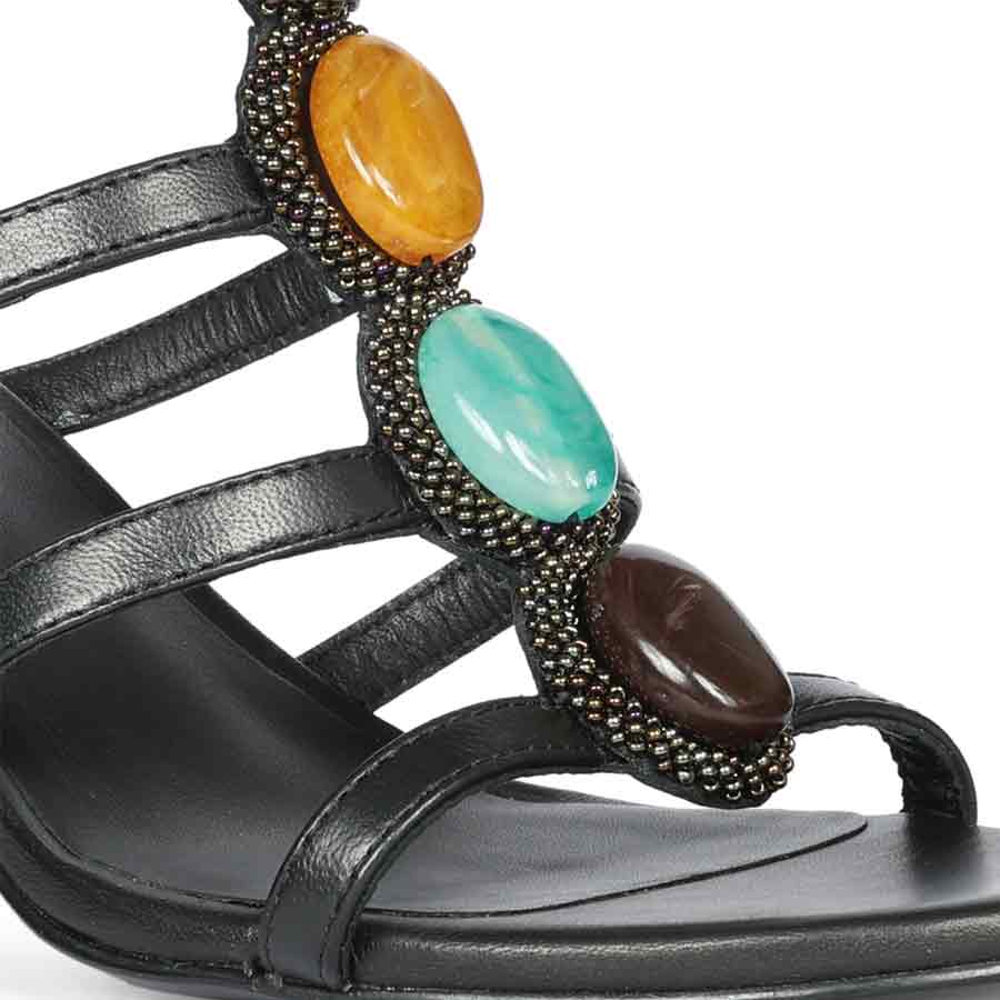 Close-up of multi stone embellishment on Saint Monroe black leather stilettos