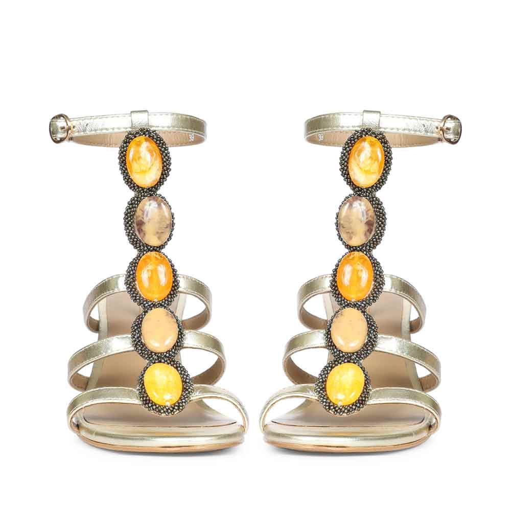 Close-upFront view embellishment on Saint Monroe metallic gold leather stilettos