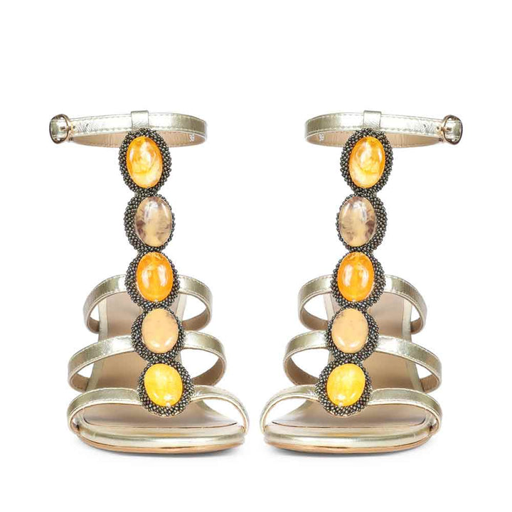 Close-upFront view embellishment on Saint Monroe metallic gold leather stilettos