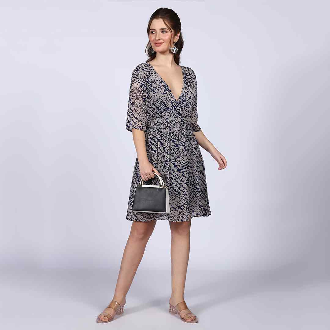 Women's navy abstract print mini dress by Saint, side view showing fit-and-flare hem.