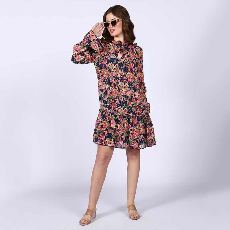 Women's blue multi bloom mini dress by Saint Nerina, front view styled with sunglasses.