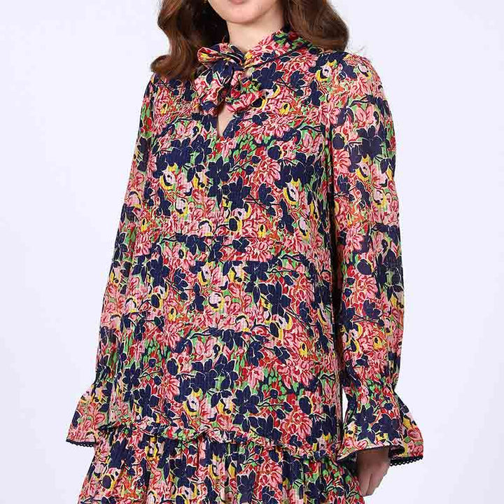Close-up of tie neck and bell cuff on Saint Nerina blue multi bloom mini dress for women UK.
