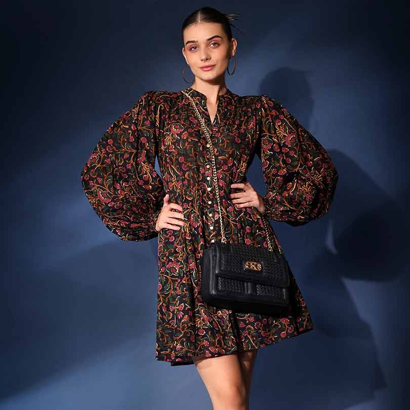 Women's navy multicolour floral short dress by Saint Onyx, front view styled with a crossbody bag.