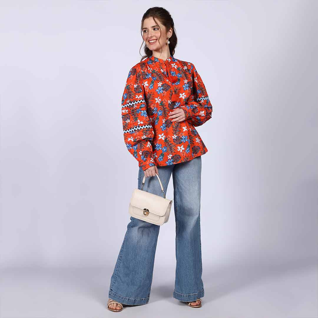 Women's orange multicolour floral cotton top for women UK, front view styled with wide-leg jeans.