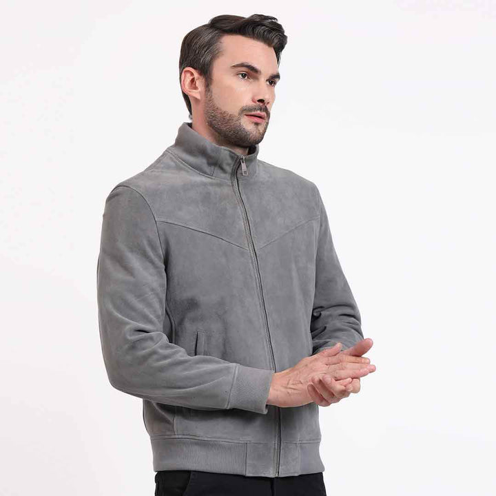 Side view of a man wearing a grey jacket with a stand collar.