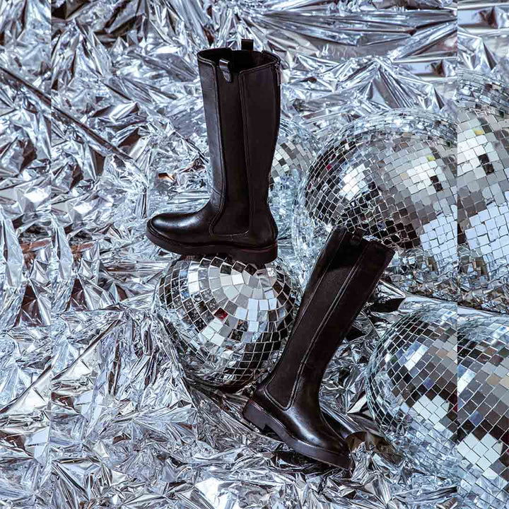 Saint Pietro black leather knee high boots, styled editorial shot with disco ball props