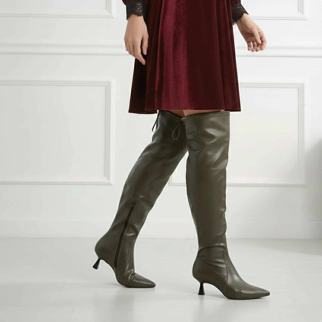 Women's olive above the knee boots UK by Saint Primrose, styled walking lifestyle shot