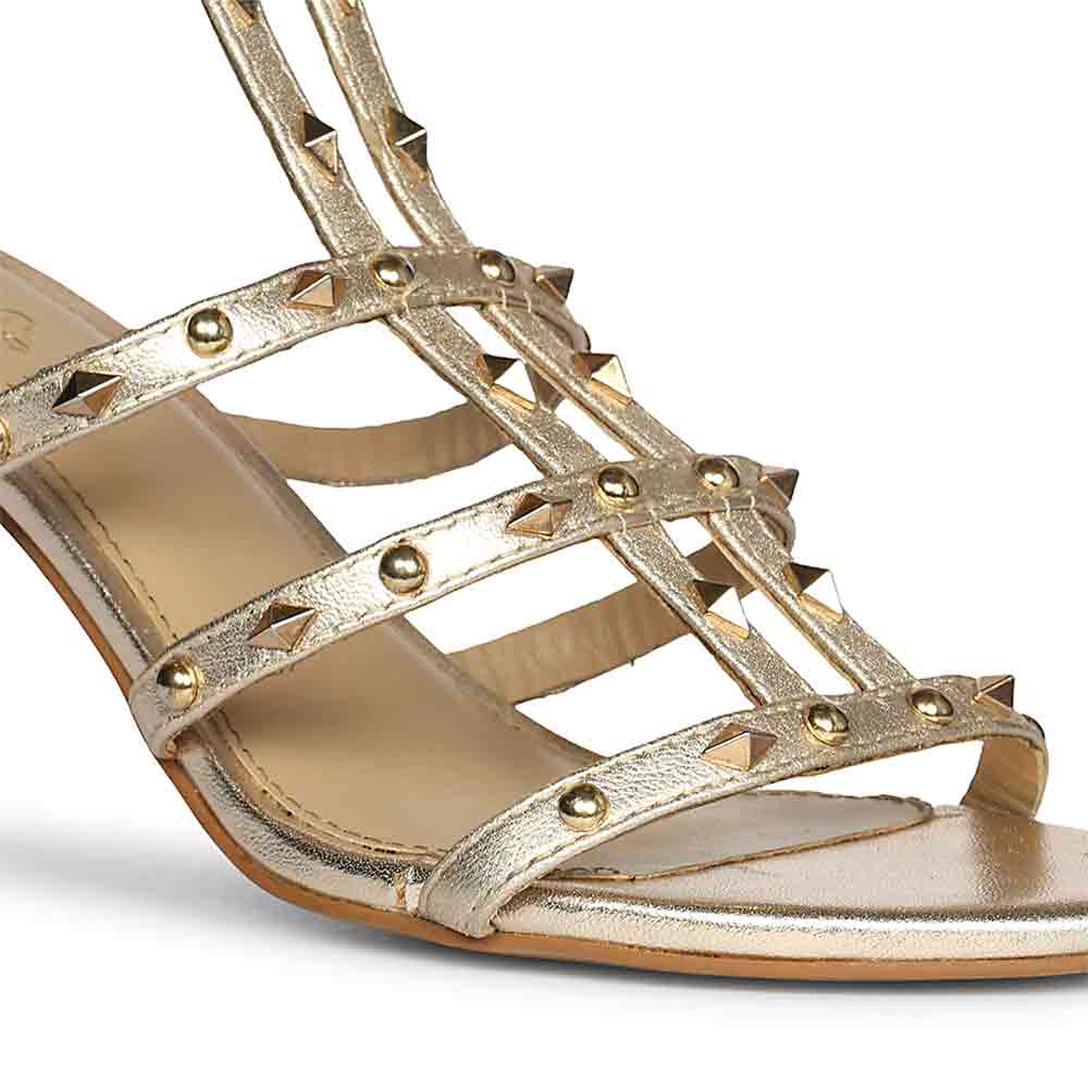 Close-up of metallic gold leather studded stilettos detail on Saint Quenel Metallic Gold Leather Studded Stilettos