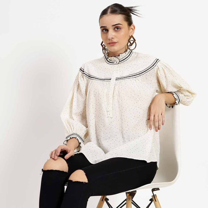 Women's ivory printed cotton top by Saint Quincy, seated lifestyle view.