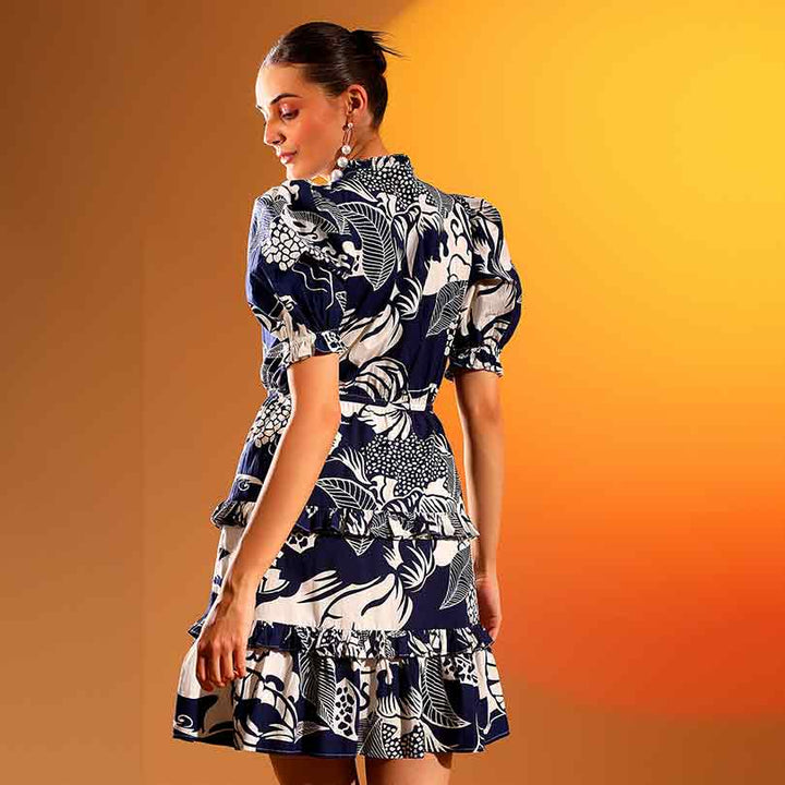 Women's navy ivory tropical print tiered mini dress by Saint Quinn, back view showing tiered ruffle skirt.