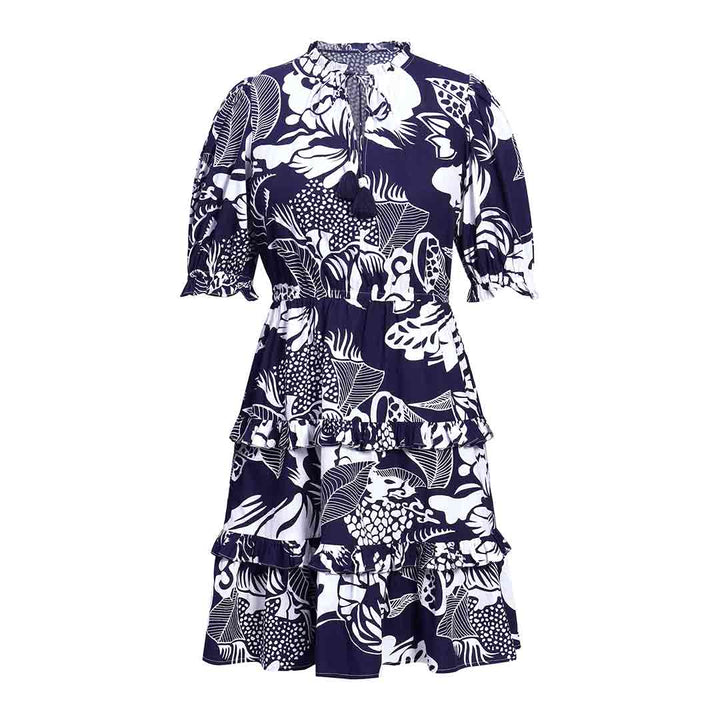 Saint Quinn navy ivory tropical print tiered mini dress for women UK, shown flat with tie neck and puff sleeves.