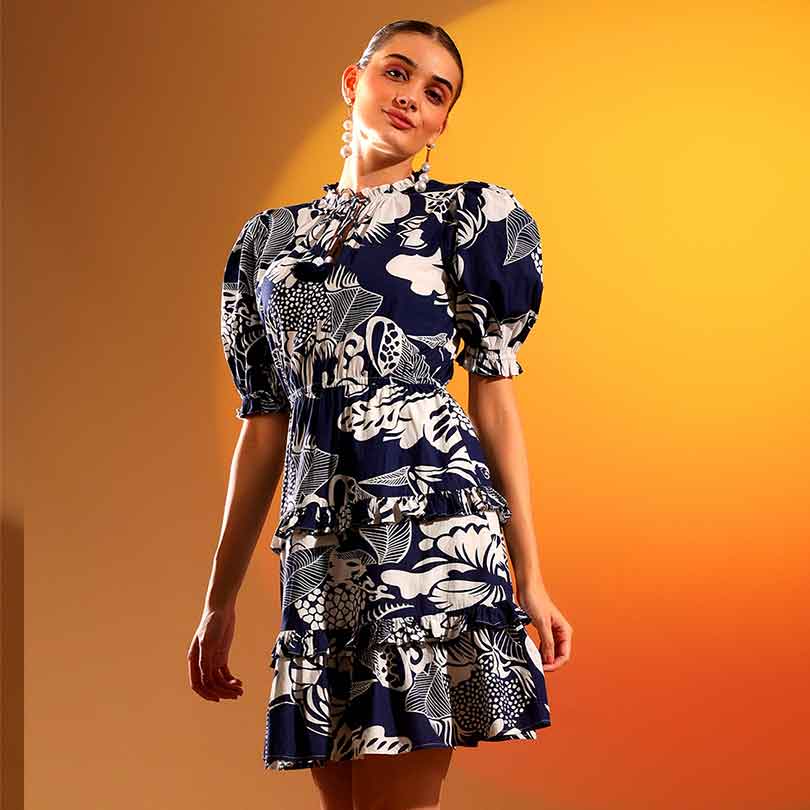 Saint Quinn navy ivory tropical print tiered mini dress for women UK, three-quarter front view.