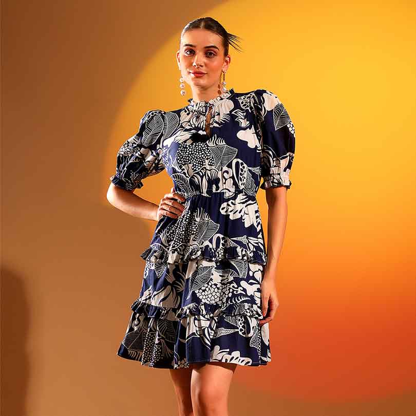 Women's navy ivory tropical print tiered mini dress by Saint Quinn, front view.