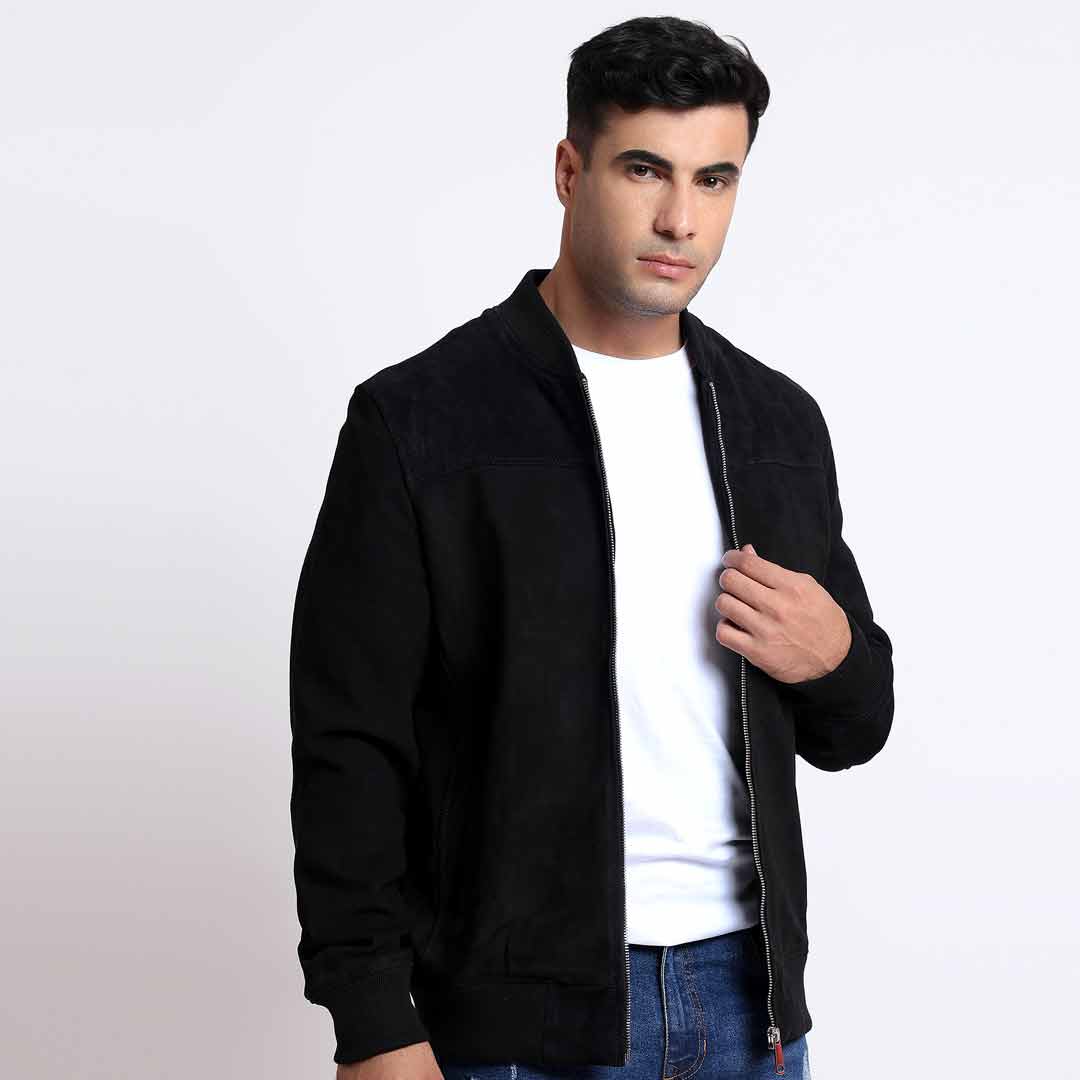Close view of a man wearing a black bomber jacket.