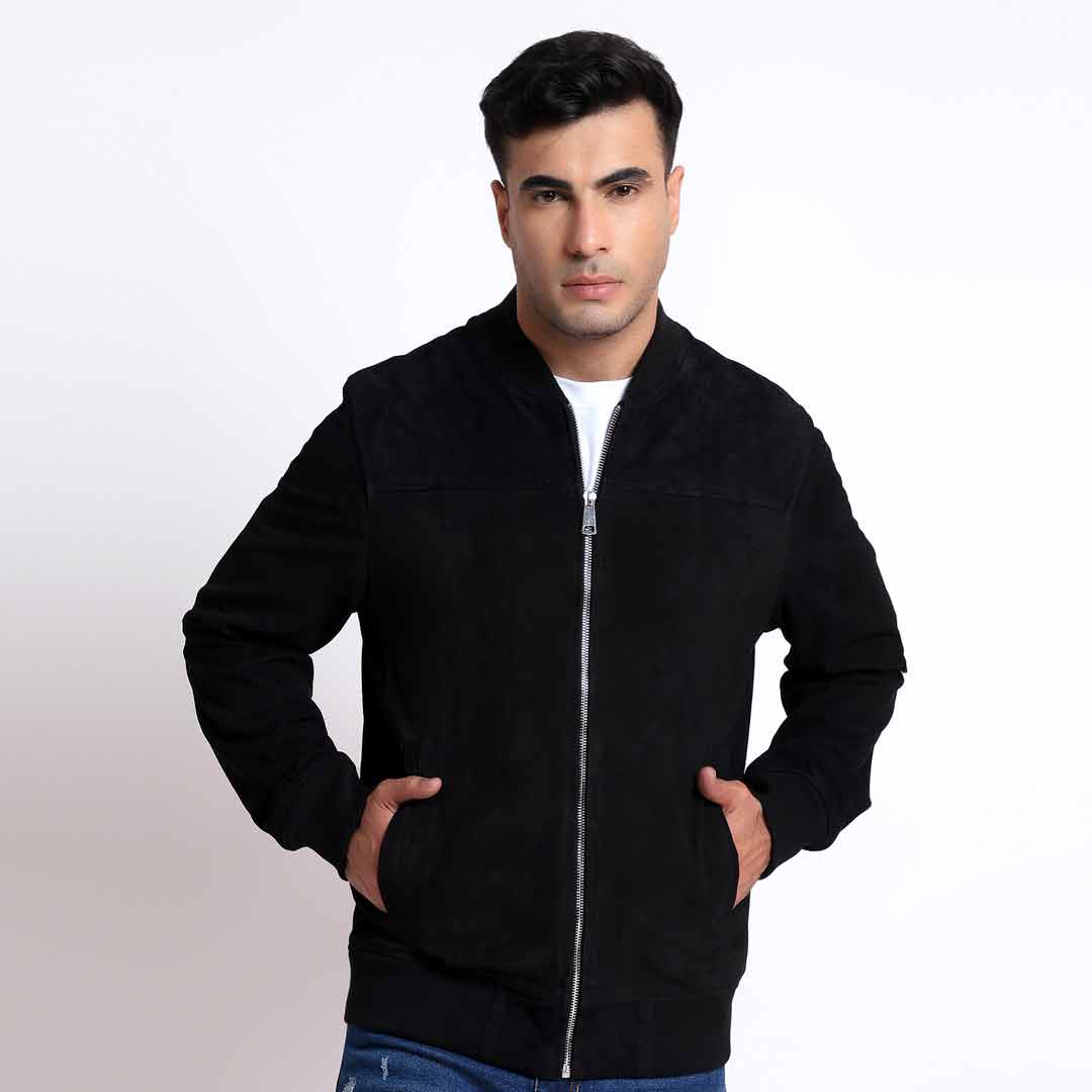 Man wearing a black bomber jacket with a ribbed collar and cuffs.