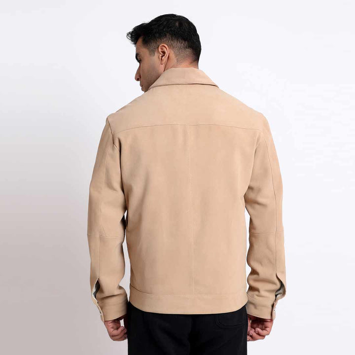 Back view of a man wearing a tan/beige suede jacket.