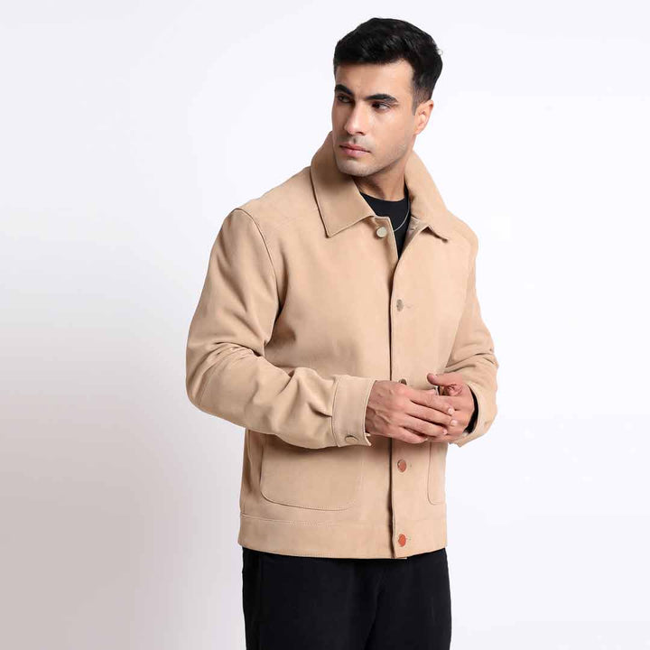 Man wearing a tan/beige suede jacket with a collar.