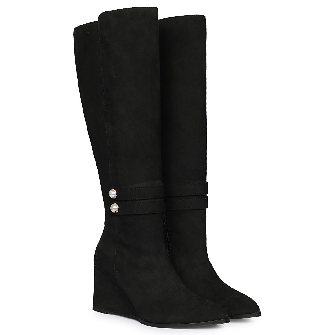 Black suede knee high boots for women UK, pair view showing pearl-button strap and wedge heel
