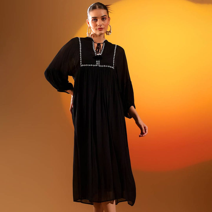 Saint Roxanne black crepe midi dress for women UK, front walking view.