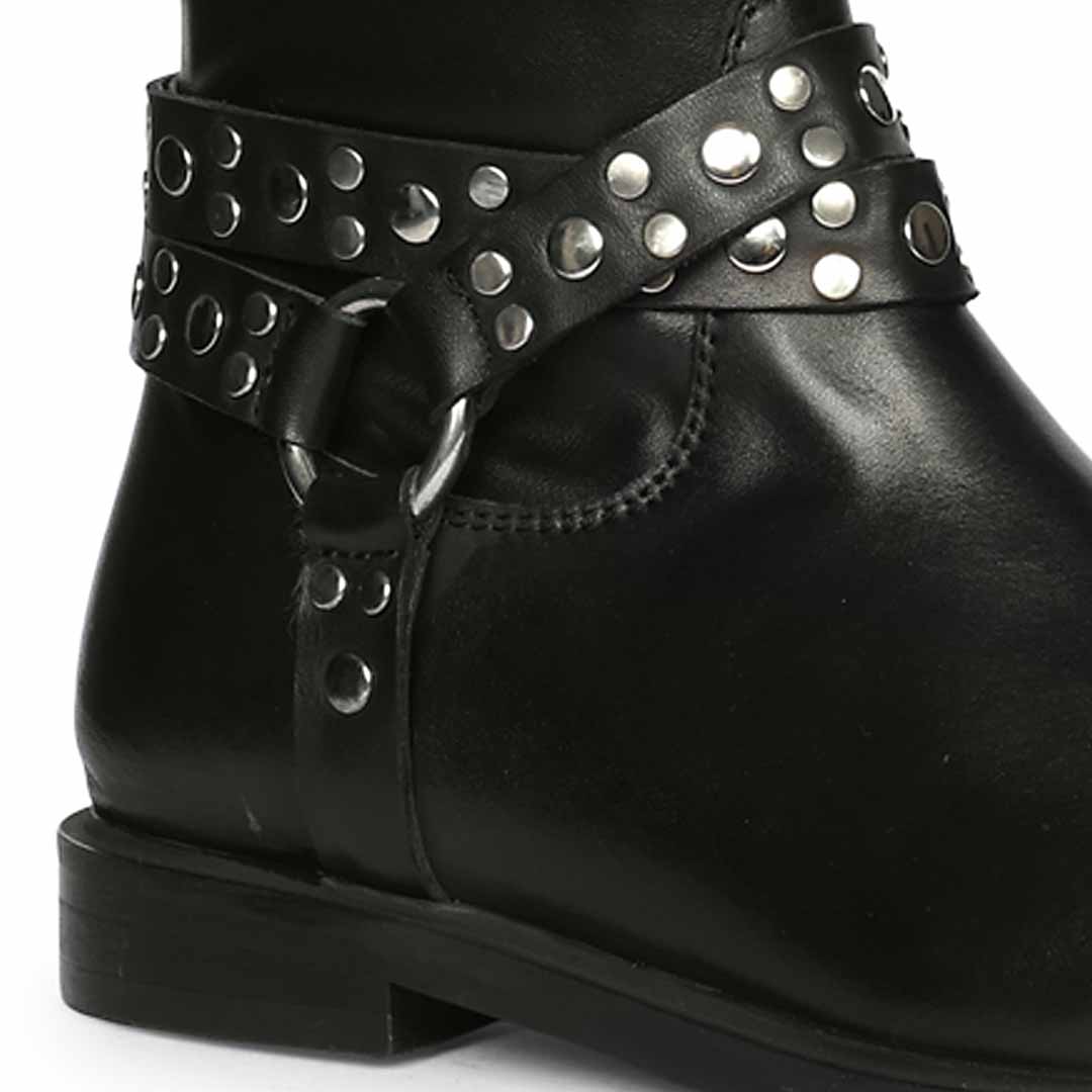 Close-up of studded O-ring harness strap on Saint Selene black long boots