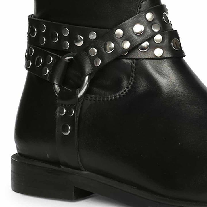 Close-up of studded O-ring harness strap on Saint Selene black long boots