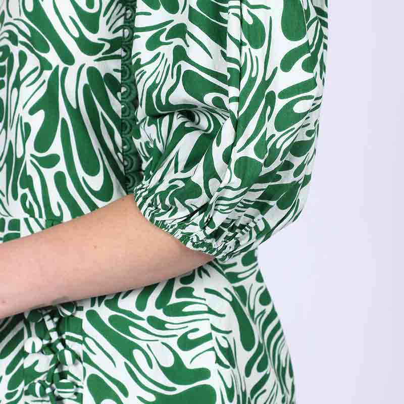Close-up of scalloped neckline trim on Saint Solene green swirl-print short dress for women UK.