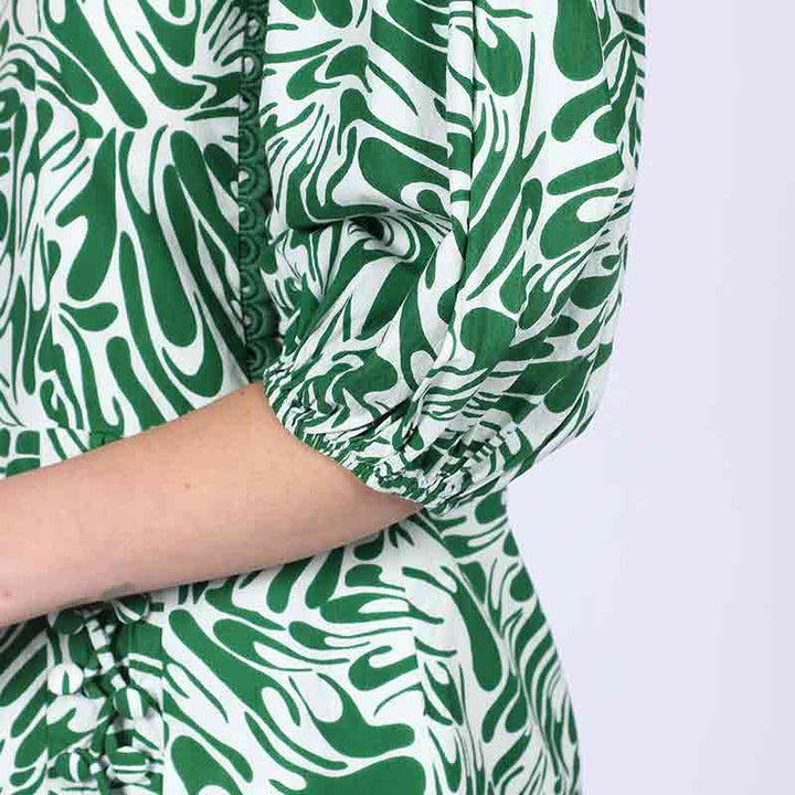 Close-up of scalloped neckline trim on Saint Solene green swirl-print short dress for women UK.