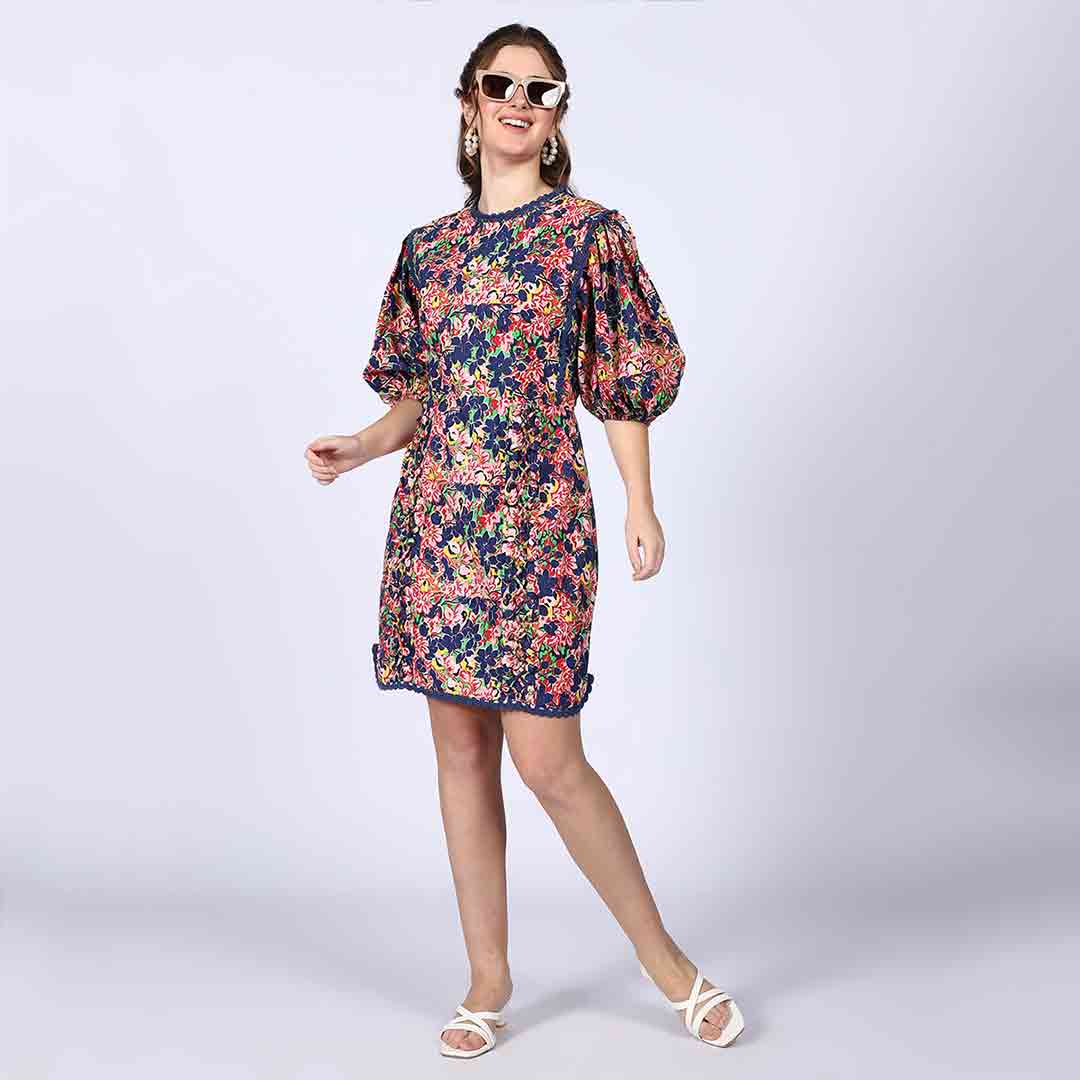 Women's multicolour floral short dress by Saint Solene, front view styled with sunglasses.