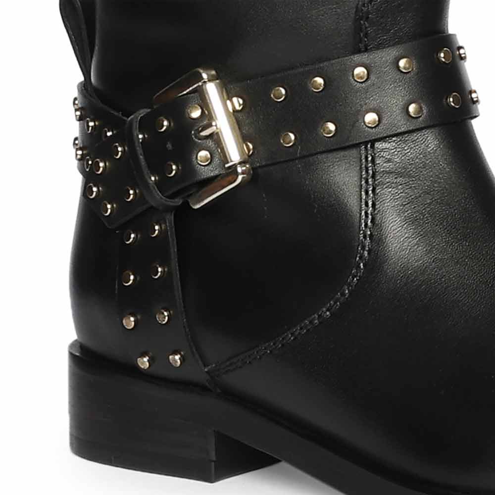 Close-up of gold studded buckle strap on Saint Soraya black leather long boots