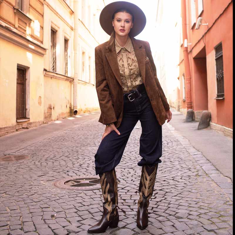 Women's brown leather knee high boots by Saint Tiziana, styled with a suede blazer, lifestyle view