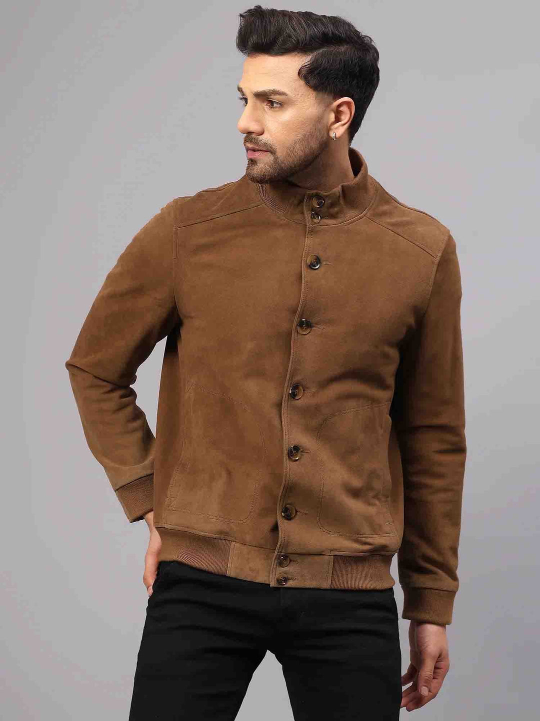 Back view of a tan suede jacket showing the back seam and ribbed hem.