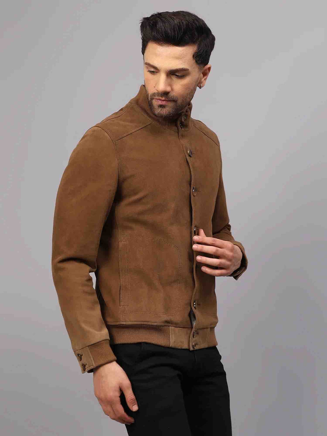 Side view of a buttoned tan suede jacket with a stand collar.