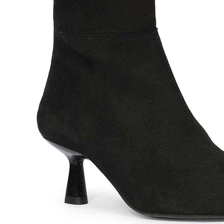 Close-up of flared kitten heel on Saint Valeria black suede knee high boots