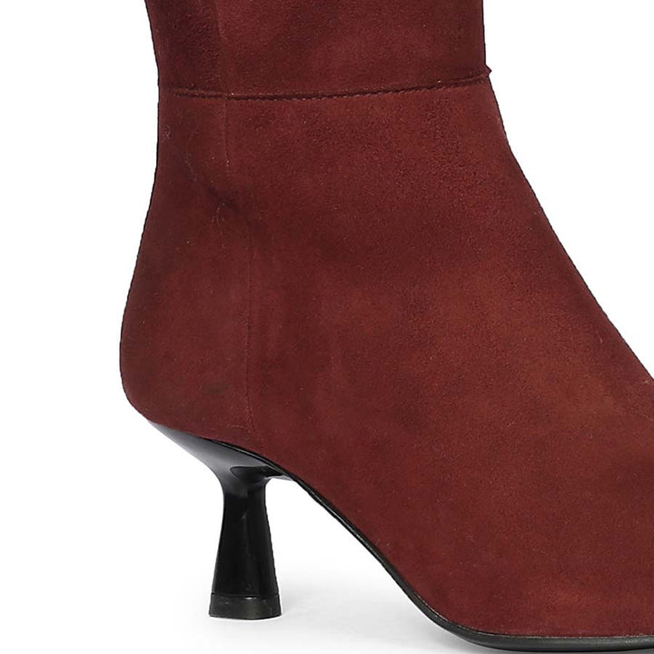Close-up of flared kitten heel on Saint Valeria bordo suede knee high boots